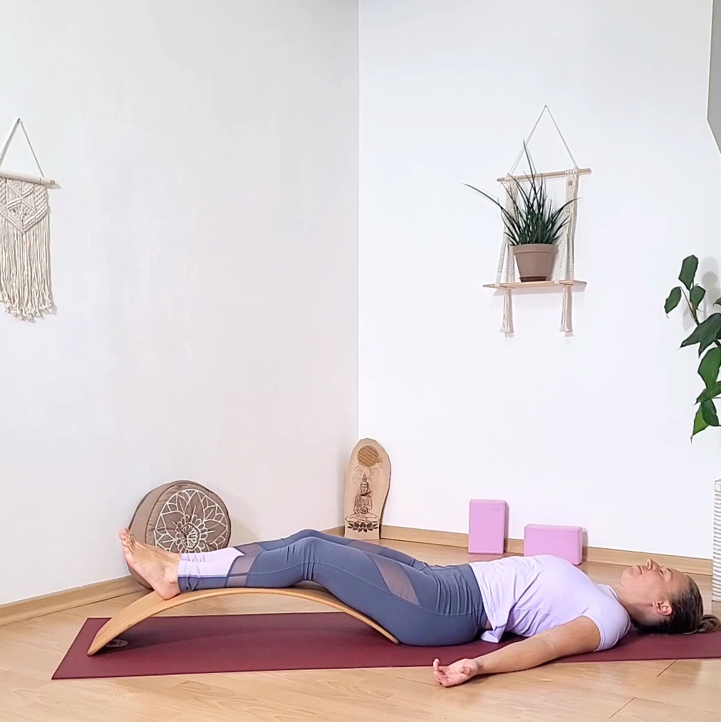 Yoga Lehrerin Sabrina in entspannter Rückenlage mit den Beinen auf dem Balance Board